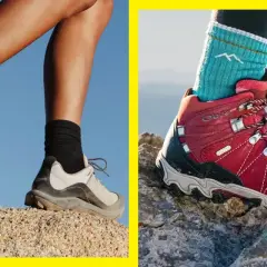 Two pairs of feet in hiking boots navigate rocky terrain. Are hiking boots necessary for this adventure?
