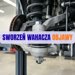 Widok na element zawieszenia samochodu, gdzie widoczny jest sworzeń wahacza. Objawy jego zużycia mogą być niepokojące.