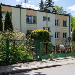 Blok mieszkalny z zielonym ogrodzeniem. Czekamy na moment, kiedy ruszy wykup mieszkań komunalnych w Warszawie, by zmienić ten widok.