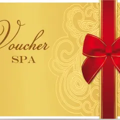 Złoty voucher do spa z ozdobną czerwoną wstążką i kokardą. Idealny prezent na relaks.