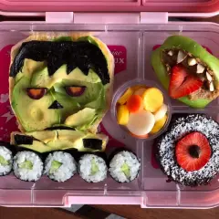 Fun vegan bento ideas! Frankenstein avocado toast, apple monster, sushi, fruit salad, and a chocolate cake.