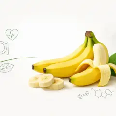 Banan, źródło witamin, prezentuje swoje bogactwo. Obok leżą plasterki i liście, a w tle symbole zdrowia i nauki.
