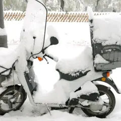 Moto cubierta de nieve, lista para no arrancar en frío.