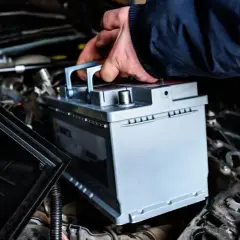 Main tenant installe une nouvelle batterie pour optimiser la durée de vie batterie start and stop de son véhicule.
