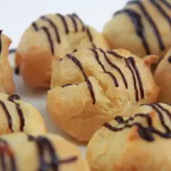 Montón de profiteroles con glaseado de chocolate. ¿De donde son los profiteroles? ¡De Francia, por supuesto!