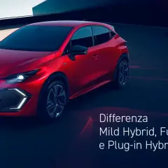 Auto ibrida rossa sportiva parcheggiata su una strada scura, con testo che spiega le differenze tra Mild Hybrid, Full Hybrid e Plug-in Hybrid.