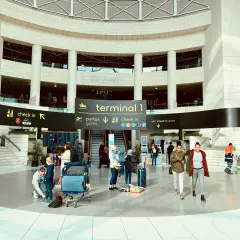 Menschen mit Gepäck im Terminal 1 des Lissabon Flughafens, bereit für die Weiterreise in die Stadt.