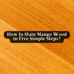 Close-up of a wooden surface, showing how to stain mango wood. The grain is visible, with a darker section on the left.