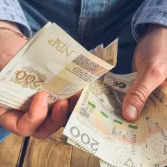 Dłonie liczą banknoty 200 zł. To może być oszczędność na emeryturę z KRUS.