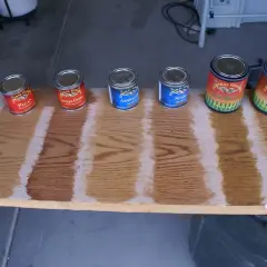 General Finishes stain color chart showing Pecan, Antique Cherry, Americano, Nutmeg, Light Brown, and Pecan wood stain samples on oak.