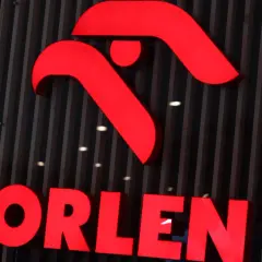 Jasny, czerwony napis ORLEN na ciemnym, pionowym tle. Symbolizuje stabilność i potencjalne najlepsze inwestycje.