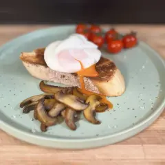 Un huevo poche perfecto sobre tostada con champiñones y tomates. ¡Así se hacen huevos poche deliciosos!