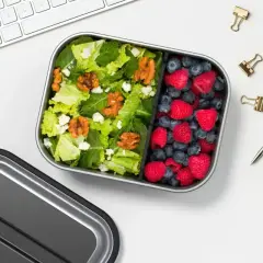 A healthy lunch bento box with a fresh salad and berries, perfect for a desk lunch, not a curry bento box.