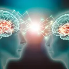 Dwa mózgi połączone siecią neuronów, symbolizujące komunikację i wyrzut dopaminy.