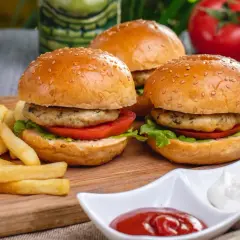 Trzy apetyczne burgery z indyka z chrupiącymi frytkami i sosami. Idealny zestaw na szybki posiłek.