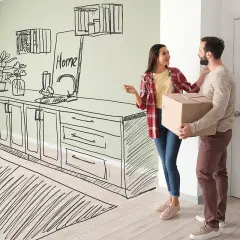 Para młoda z kartonem w rękach, marząca o kuchni z marzeń, która wkrótce stanie się rzeczywistością dzięki transzy kredytu.