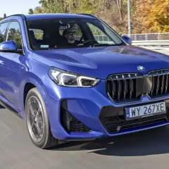 Niebieskie BMW X1 w ruchu drogowym, kierowca w okularach. Zastanawiasz się nad jego spalaniem?