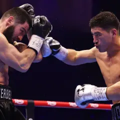 Two boxers clash in the ring. The boxer on the left, with "BET..." on his shorts, is in the light heavyweight beterbiev weight class.