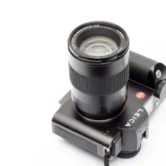 A black Leica camera with a Leica 75mm Summicron lens attached, ready to capture stunning portraits.