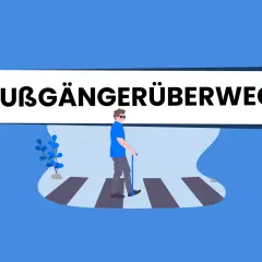 Ein Mann mit Stock und Sonnenbrille überquert den Zebrastreifen. Das Verkehrszeichen 350, Fußgängerüberweg, ist prominent platziert.