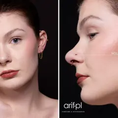 Kobieta z septum i kolczykiem w nosie (nostril). Złote ozdoby podkreślają jej urodę.