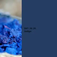 Nahaufnahme von zerstoßenem Pigment in tiefem Indigo. Die Farbe wirkt intensiv und fast samtig.