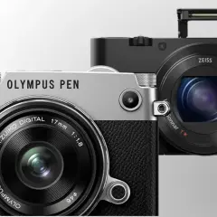 Dwa nowoczesne bezlusterkowce: srebrny Olympus PEN i czarny Sony z obiektywem Zeiss.