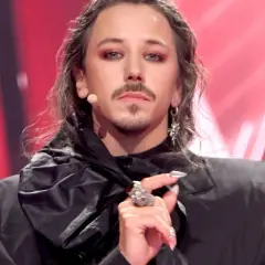 Michał Szpak, artysta o wyrazistym wizerunku, w czarnym stroju i z charakterystycznym makijażem. Czy Michał Szpak jest gejem? Jego styl budzi pytania.