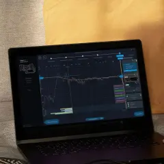 Na ekranie laptopa widoczny jest wykres kalibracji dźwięku, prawdopodobnie z użyciem systemu yamaha ypao.