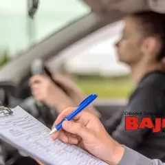 Instruktor notuje postępy kursantki. Skuteczne sposoby na stres przed egzaminem na prawo jazdy to m.in. dobra nauka i wsparcie.