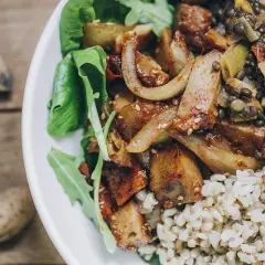 Plato con seitan salteado, lentejas, arroz integral y hojas verdes. Una deliciosa opción para tus recetas de seitan.