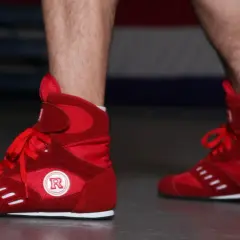 Red boxing shoes ready for intense boxing footwork drills.