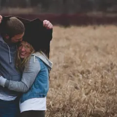 Para niego to początek związku. Przytula ją pod kurtką, oboje uśmiechnięci, w jesiennym krajobrazie.