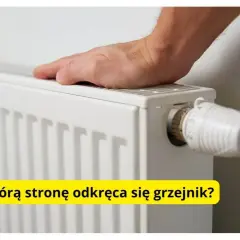 Dłoń na grzejniku, obok termostatu. Pytanie brzmi: w którą stronę się odkręca grzejnik, by było cieplej?