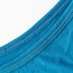 Close-up of teal fabric showing a decorative double needle topstitch with colorful threads, adding a vibrant detail to the garment's edge.
