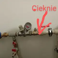 Cieknie zawór antyskażeniowy za wodomierzem. Czerwona strzałka wskazuje miejsce wycieku.