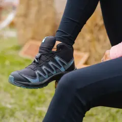Czarny but trekkingowy Salomon z niebieskimi detalami, idealny na przygodę.
