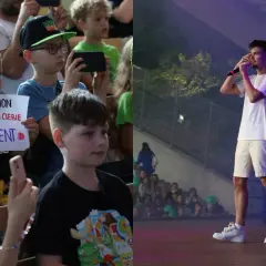 Dzieci na koncercie, jedno z nich trzyma transparent "PALION mam dla ciebie prezent". Na scenie artysta.