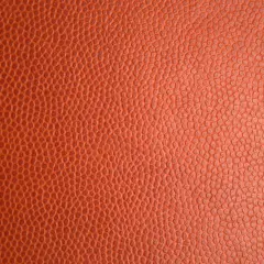 Texture d'un ballon de basket orange. Pour savoir si c'est du vrai cuir, observez la régularité des alvéoles.