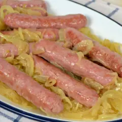 Salchichas al vino tiernas y jugosas, cocinadas con cebolla caramelizada en una salsa sabrosa. ¡Un plato reconfortante!
