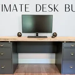 A modern DIY computer desk with a light wood top, dark gray drawers, and a monitor setup.