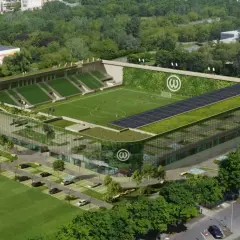 Nowoczesny warta poznań stadion z zielonymi dachami, panelem słonecznym i pionową ścianą zieleni.