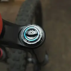 Close-up of an orange MTB frame and black suspension fork with a "Charger" damper adjustment knob, part of the mtb suspension setup.