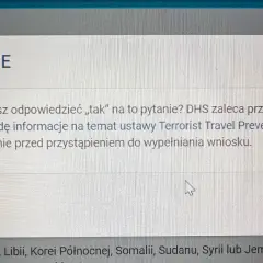 Okno dialogowe z ostrzeżeniem "OSTRZEŻENIE" dotyczące pytania o podróże do USA.