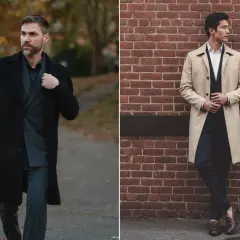 Deux hommes portant des manteaux, un noir et un beige, devant un mur de briques et dans un parc.