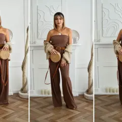 Elegancki, brązowy kombinezon damski bez ramiączek, uzupełniony beżowym kardiganem i okrągłą torebką.