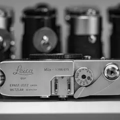 A vintage Leica MDa camera, a classic piece of photographic history, sits in the foreground.