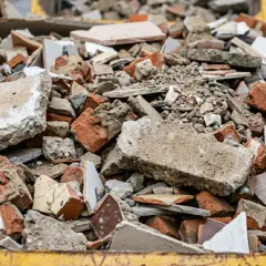 Gruz budowlany w kontenerze: potłuczona cegła, beton, płytki.