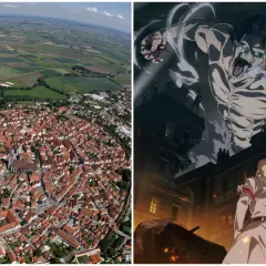 Luftaufnahme einer Stadt mit roten Dächern und einem riesigen Titanen, der über Gebäude ragt. Hier spielt Attack on Titan.