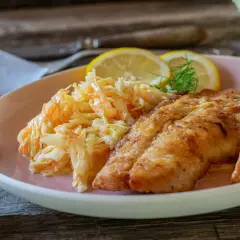 Chrupiący filet rybny z ziemniakami i świeżą surówką do ryby.